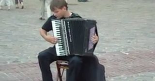 Street artist playing Vivaldi on accordion