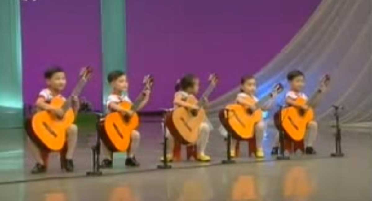 North Korea children playing the guitar.